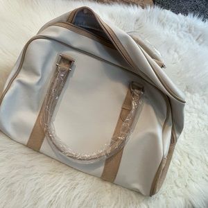 Estée Lauder cream and tan bag.